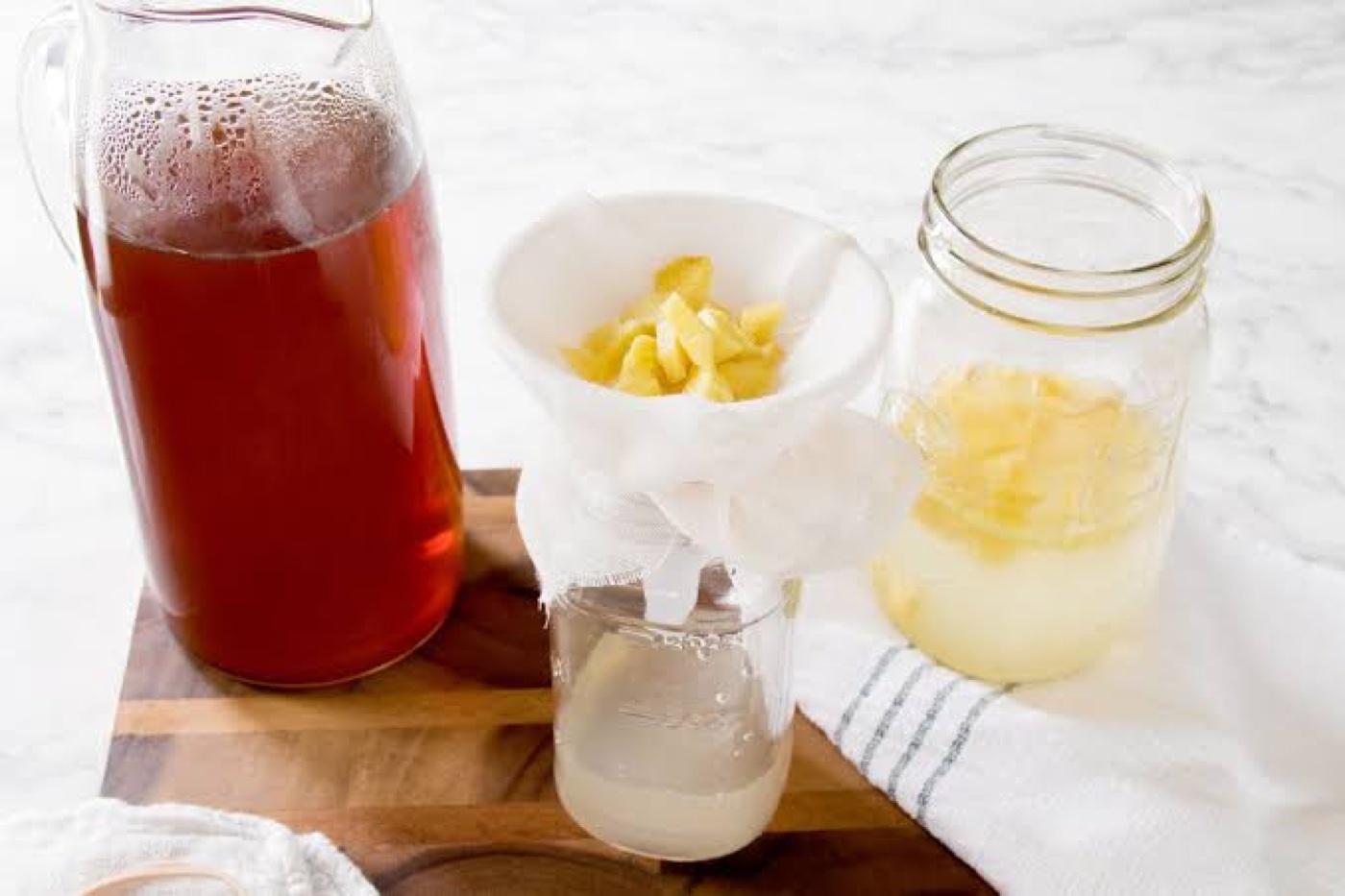 Straining the active ginger bug culture before making a batch of probiotic drinks